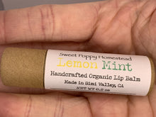 Load image into Gallery viewer, Handcrafted lemon mint scented lip balm  view in hand
