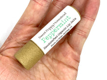 Load image into Gallery viewer, Organic peppermint lip balm in palm of hand
